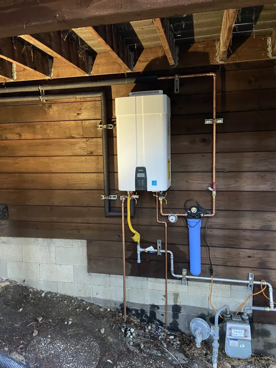 Tankless water heater installation with copper piping and water filter