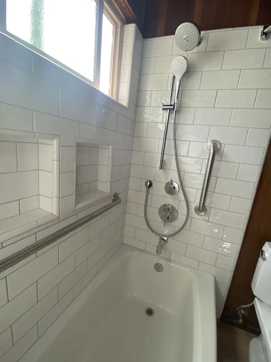 Tub-shower combo with white subway tile and chrome fixtures